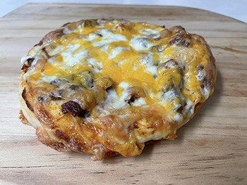 photo of a single cheeseburger pizza